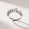 Side profile of a K18 white gold ring set with pear-shaped and round diamonds