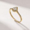 Angled view of a pear-cut diamond halo ring in K14 yellow gold