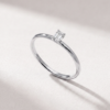 Angled view of an emerald-cut diamond solitaire ring in K14 white gold