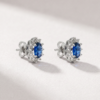 Side view of K18 white gold sapphire and diamond halo earrings with butterfly backs