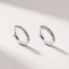 Angled view of diamond huggie earrings in K18 white gold