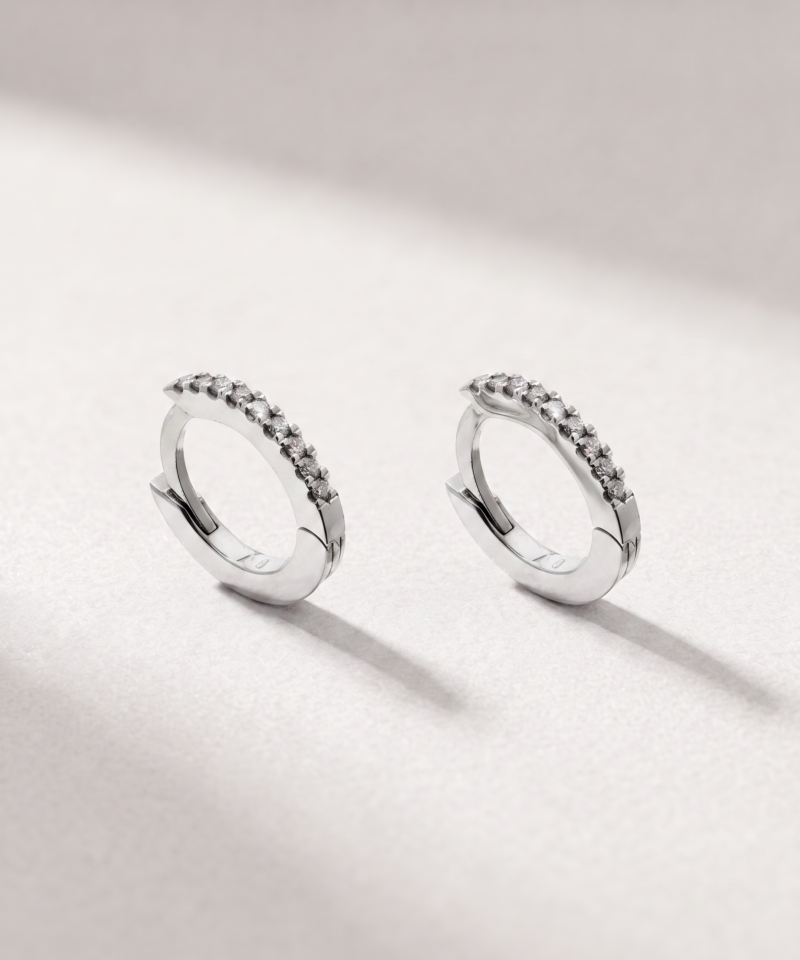 Angled view of diamond huggie earrings in K18 white gold