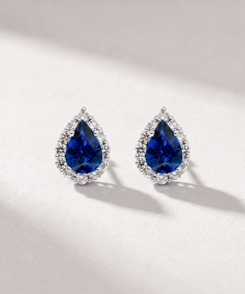 Pear-cut sapphire and diamond halo earrings in K18 white gold shown from the front