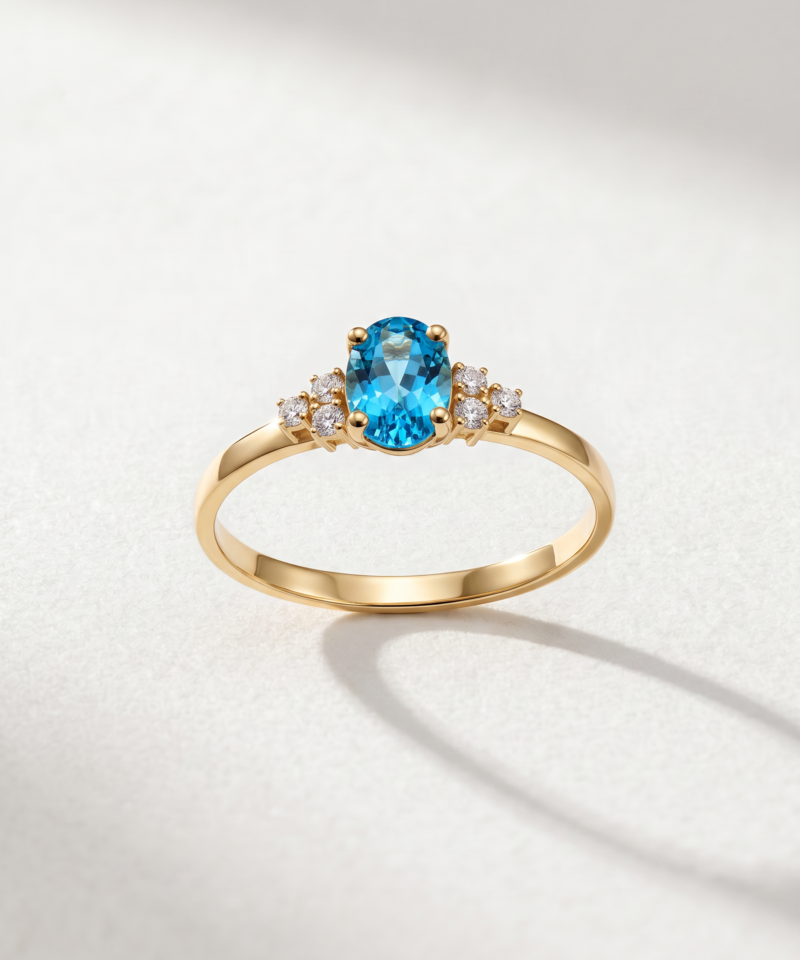 Oval-cut blue topaz cluster ring in K14 yellow gold